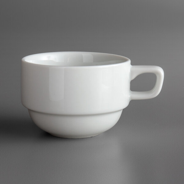 A Oneida Royale bright white porcelain cup with a handle on a gray surface.