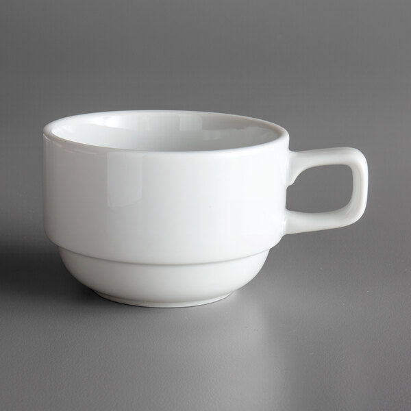 A white Oneida Royale porcelain cup with a handle on a gray surface.