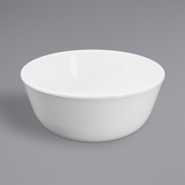 An Elite Global Solutions white melamine bowl on a gray surface.