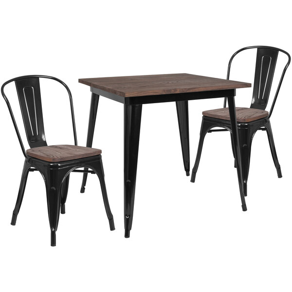 A Flash Furniture black metal and wood table with two chairs.