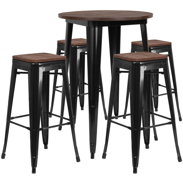A Flash Furniture round bar height table with black metal and wood top with three black backless stools.