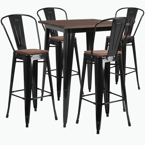 A Flash Furniture black metal bar table with four black chairs.