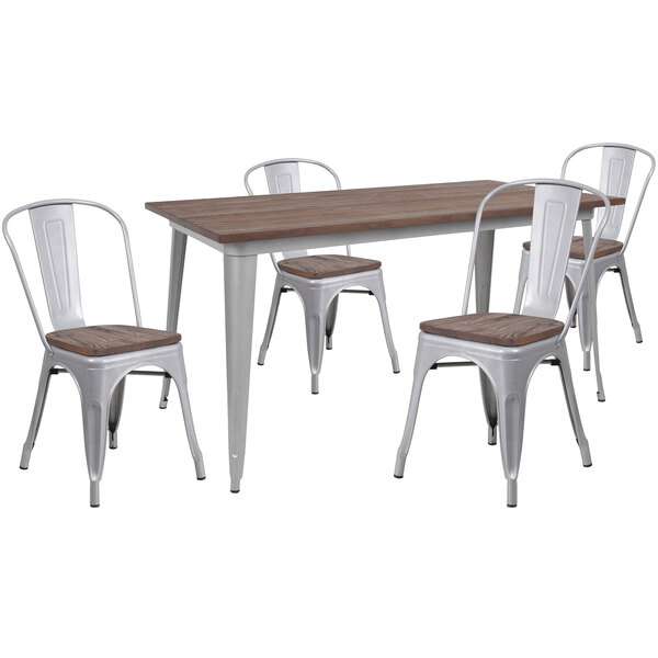 A white metal and wood table with four white metal chairs.
