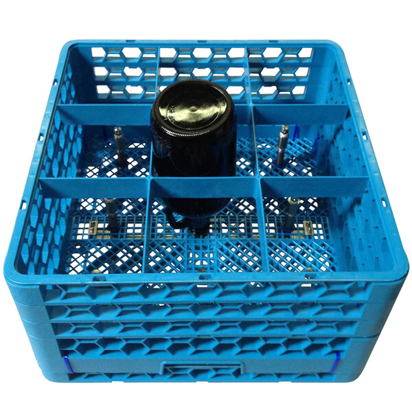 A blue plastic bottle washer rack with black bottles inside.