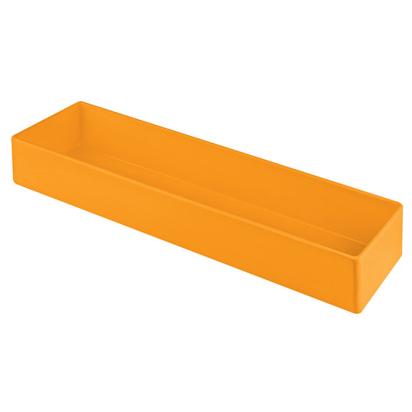 An orange cast aluminum rectangular bowl on a counter.