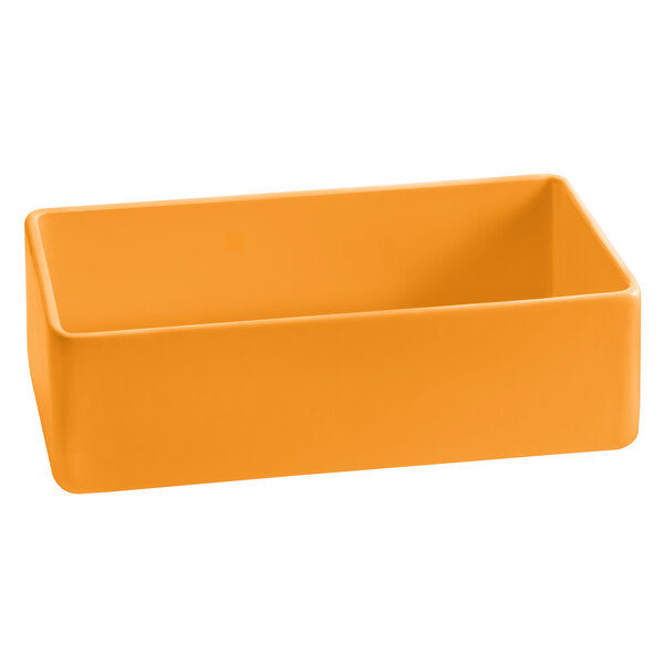 An orange rectangular cast aluminum bowl with a white background.