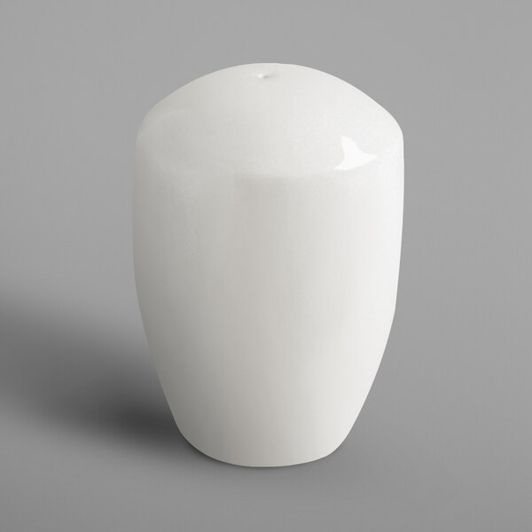 A white porcelain pepper shaker.