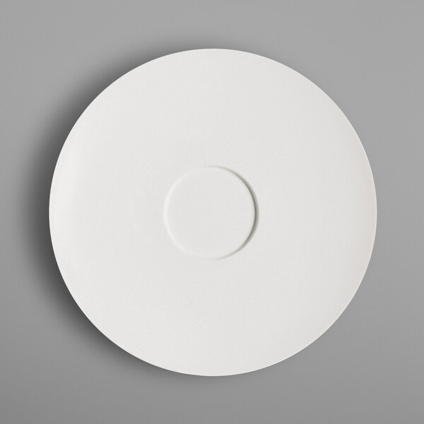 A white RAK Porcelain saucer with a circle in the middle.