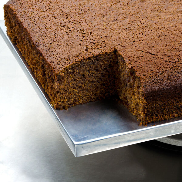 A metal tray with a 5 lb. Devil's Food Chocolate Cake mix on it with a slice missing.