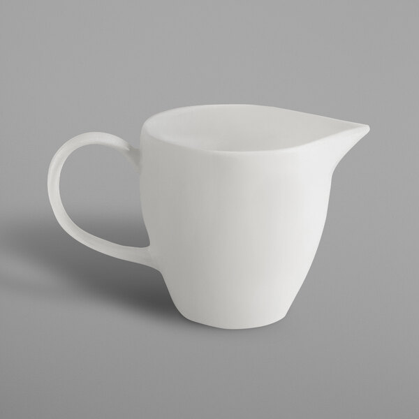 A white pitcher with a handle.