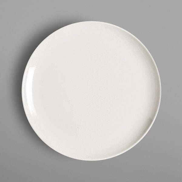 A RAK Porcelain ivory flat coupe plate on a gray background.