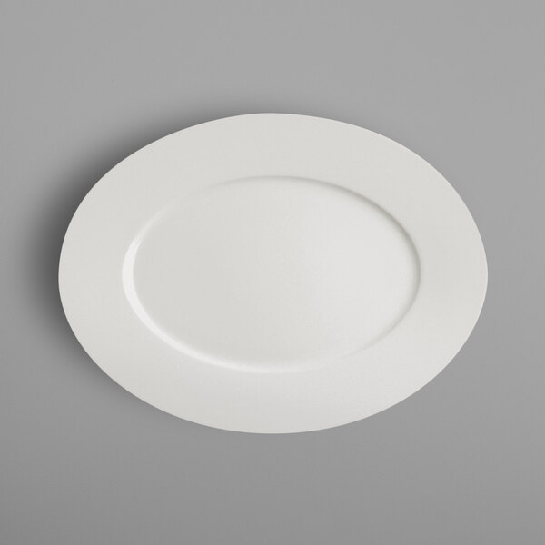 A RAK Porcelain ivory porcelain oval plate on a gray surface.