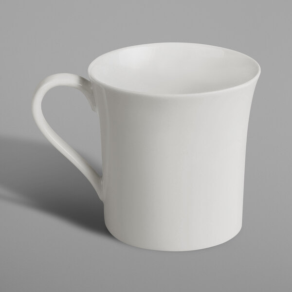 A RAK Porcelain ivory coffee cup with a handle on a white surface.