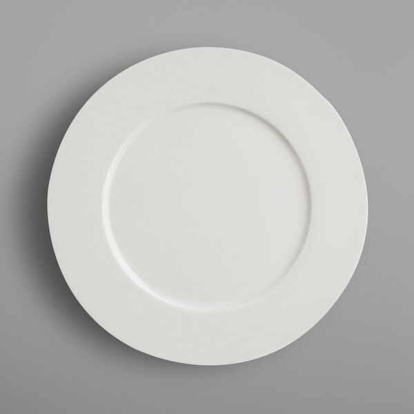 A RAK Porcelain ivory porcelain flat plate with a circle in the middle on a white background.