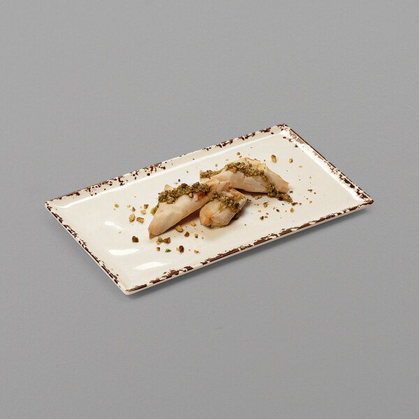 A white rectangular GET Tuscan melamine platter with food on it.