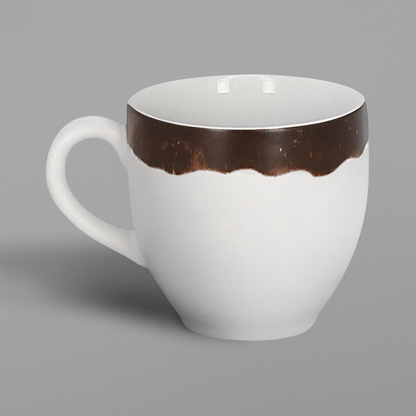 A white porcelain espresso cup with an oak brown and white design.