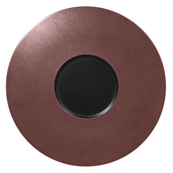A RAK Porcelain bronze and black metal fusion flat plate with a black circle in the center.