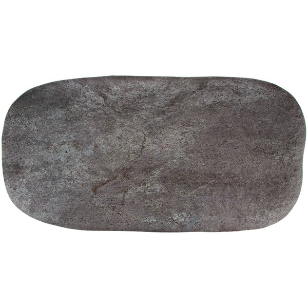 A close-up of a slate rectangular platter with a stone surface.