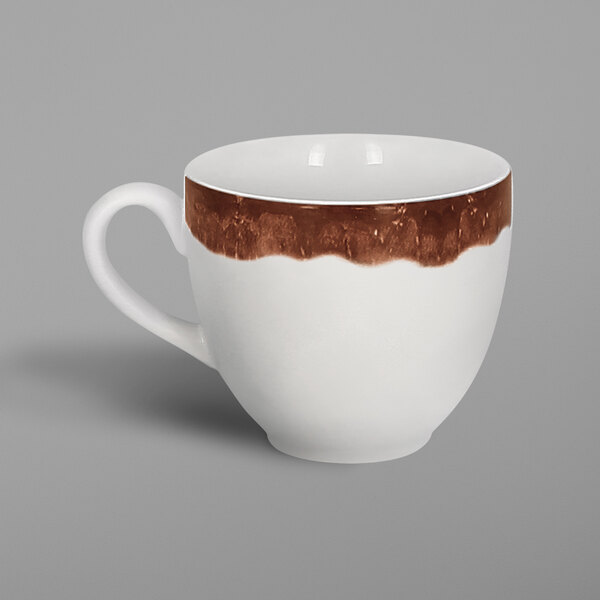 A white porcelain coffee cup with brown paint on it.