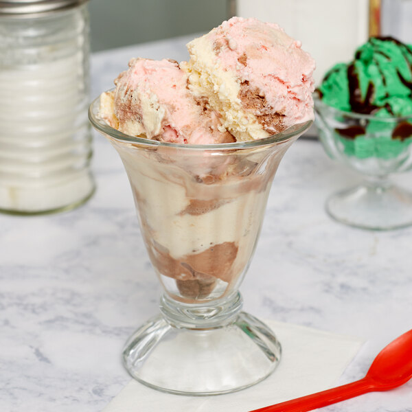 A Libbey tulip sundae glass filled with ice cream and chocolate sauce.