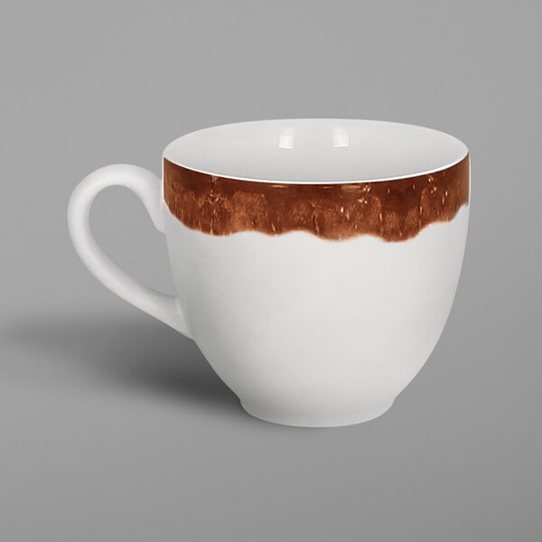A white porcelain cup with brown paint in a striped pattern.