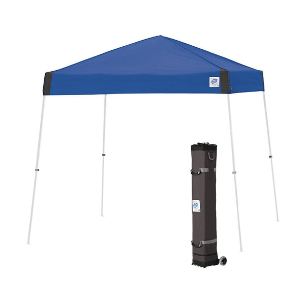 A blue E-Z Up Vista canopy tent with a white frame in a black bag.
