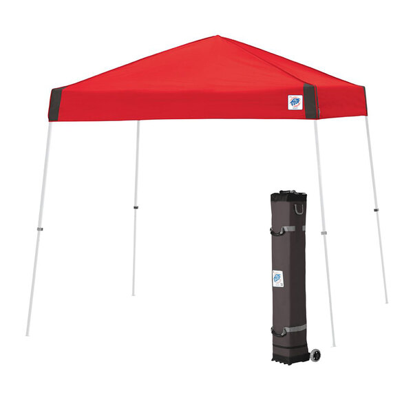 A red E-Z Up canopy with a white bag on it.