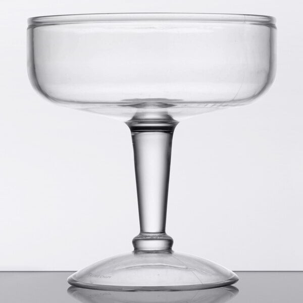 A clear plastic margarita glass with a stem.