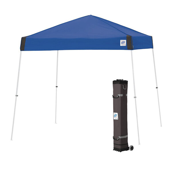 A royal blue E-Z Up canopy with a white frame in a black bag.