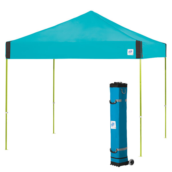 A blue E-Z Up canopy with a limeade frame in a bag on a wheeled cart.