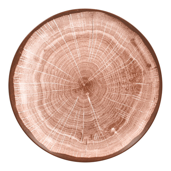 A close up of a RAK Porcelain Woodart walnut brown porcelain coupe plate with a wood design.