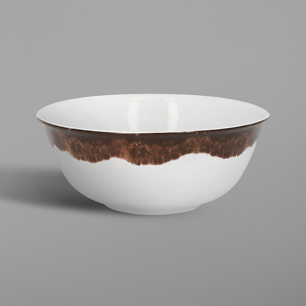 A white porcelain bowl with brown paint on the edges.