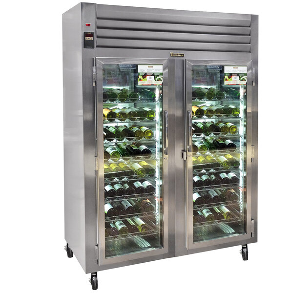 A Traulsen wine refrigerator with glass doors and wine bottles.