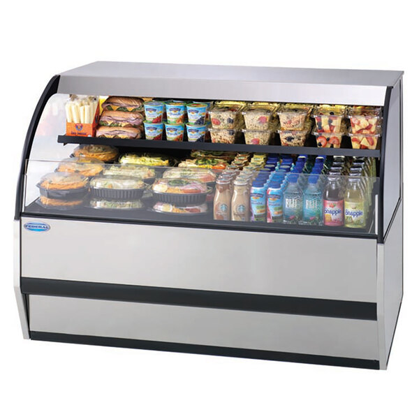 A Federal Industries combination service top over refrigerated self-serve merchandiser with food and drinks on shelves.