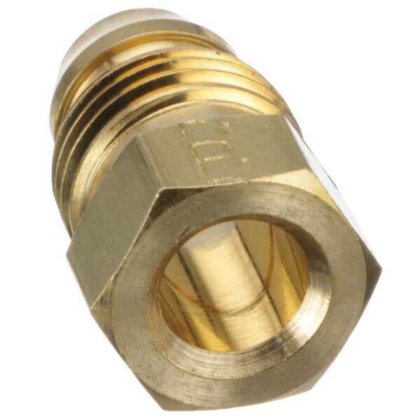 A close-up of a Noble Warewashing brass threaded fitting with a nut.