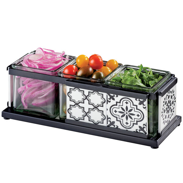 A black Cal-Mil condiment organizer with vegetables and herbs in it.