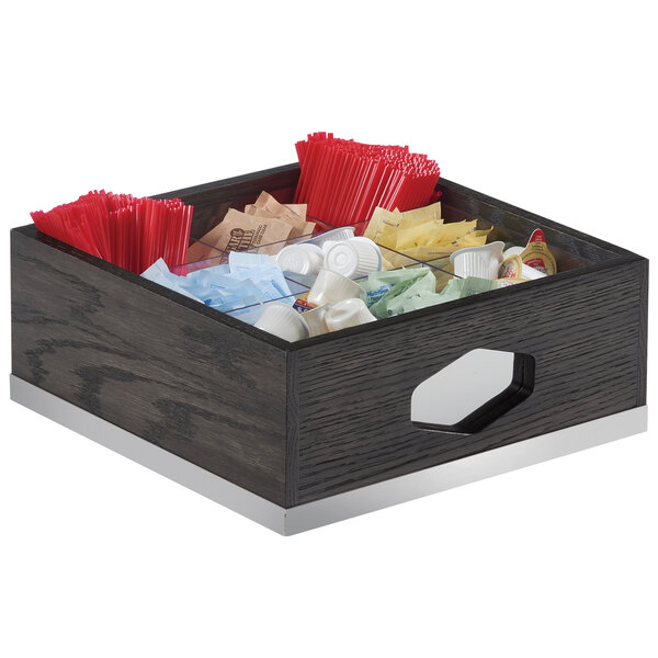 A wooden box with a variety of condiments in it.