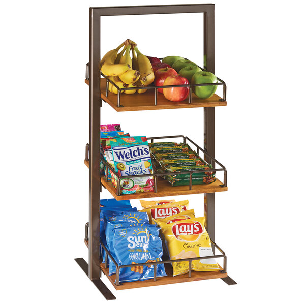A Cal-Mil Sierra 3-tier metal merchandiser shelf with fruit and snacks.