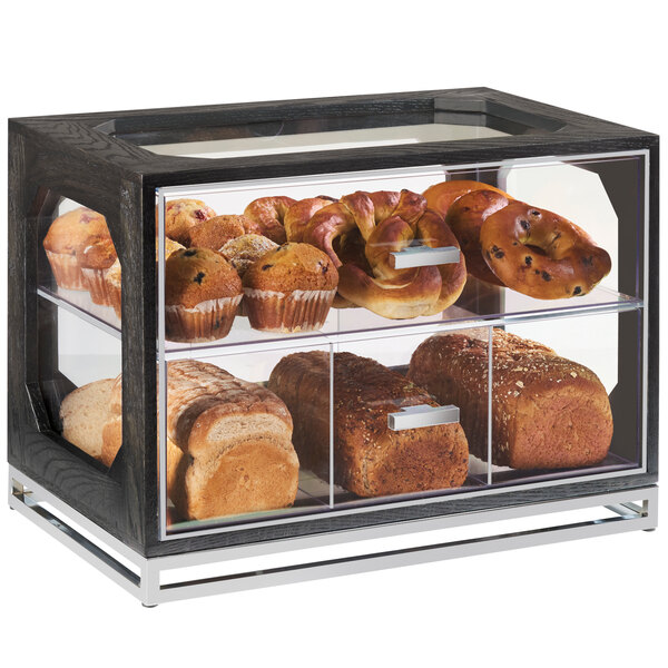 A Cal-Mil oak wood bread case with bread loaves displayed inside.