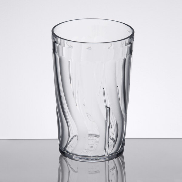A clear Dinex plastic tumbler with a swirl pattern.