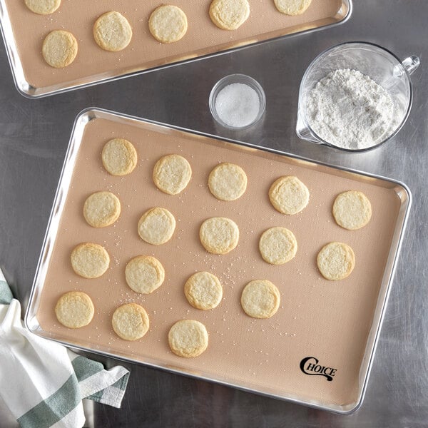 A tray of cookies on a Choice Full Size Silicone baking mat.