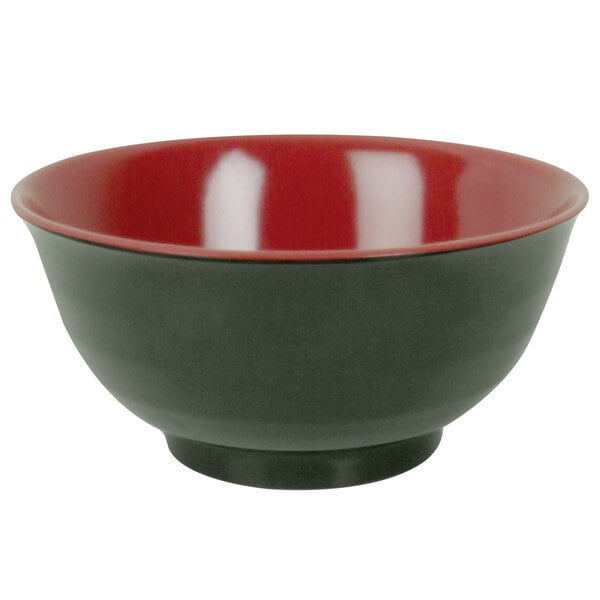 A close-up of a red and black Thunder Group melamine noodle bowl with a white interior.