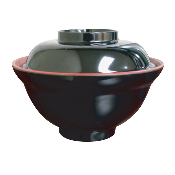 A black melamine bowl with a red rim and lid.