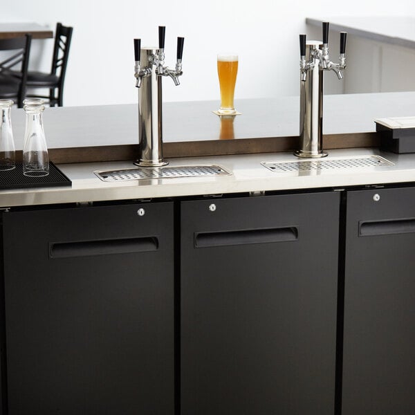 An Avantco black rectangular beer dispenser with 2 taps on a counter.