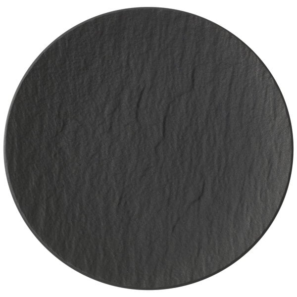A close-up of a black round Villeroy & Boch The Rock Shale Porcelain Plate.