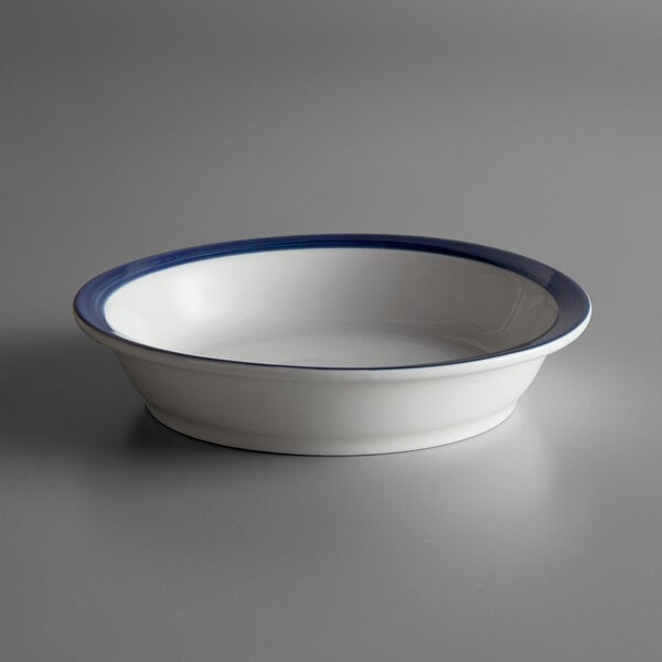 A white Libbey Lunar Bright porcelain bowl with a blue rim.