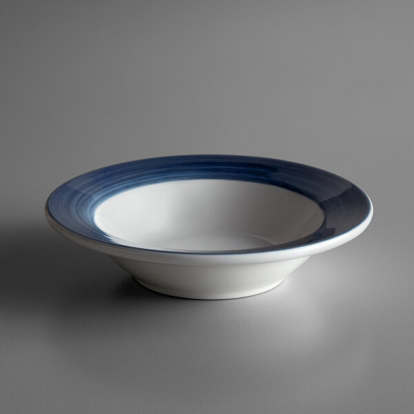 A white porcelain Libbey bowl with a blue banded rim.