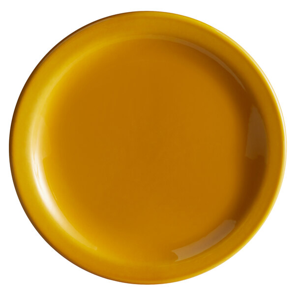A close up of a yellow Libbey Cantina porcelain plate with a white background.
