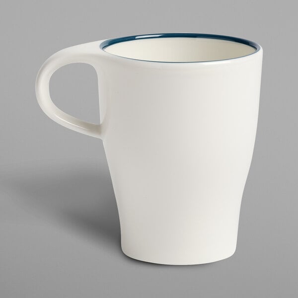 A white Villeroy & Boch porcelain mug with a blue rim.