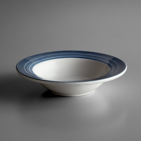 A white Libbey porcelain bowl with a blue striped rim.